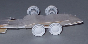  The car raced with white wheels and no hubcaps. The axles were removed from the base plate and tyres taken off. Unfortunately, the wheels have the hubcap cast in, so Tamiya white is sprayed over the lot. (I have since found a source of suitable aftermarket wheels for future projects such as this)